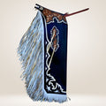 Decorative horse bridle with blue leather and white fringe on a beige background