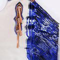 Blue leather vest with decorative patterns and fringe on a white background