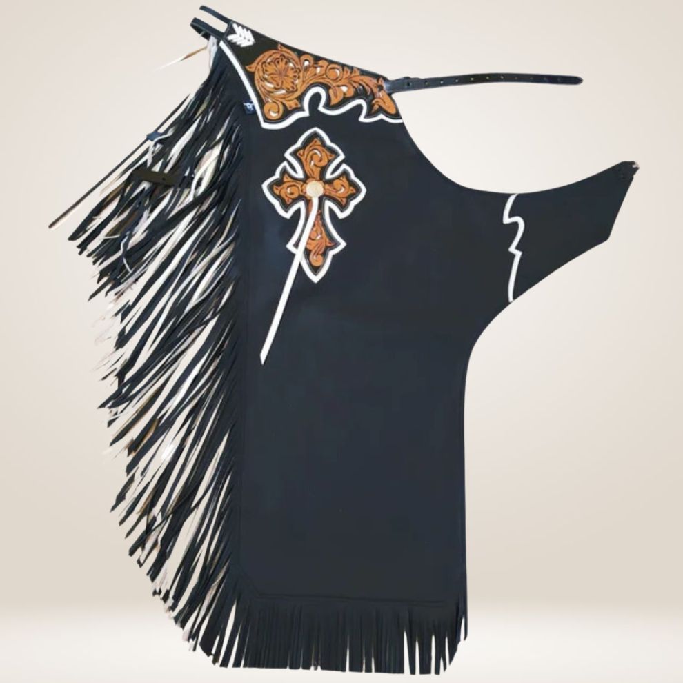 Black fringe rodeo chaps with decorative cross and embroidery on a beige background