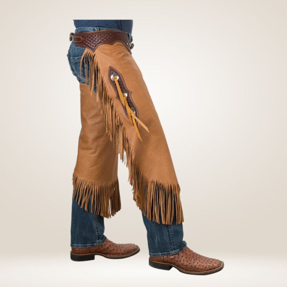 Brown leather chaps with fringes worn over blue jeans on a white background