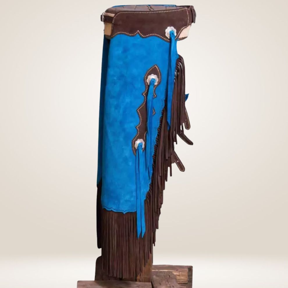 Blue and brown leather saddle blanket with fringes on a stand against a beige background