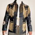 Black leather jacket with gold fringes and embroidery on a neutral background