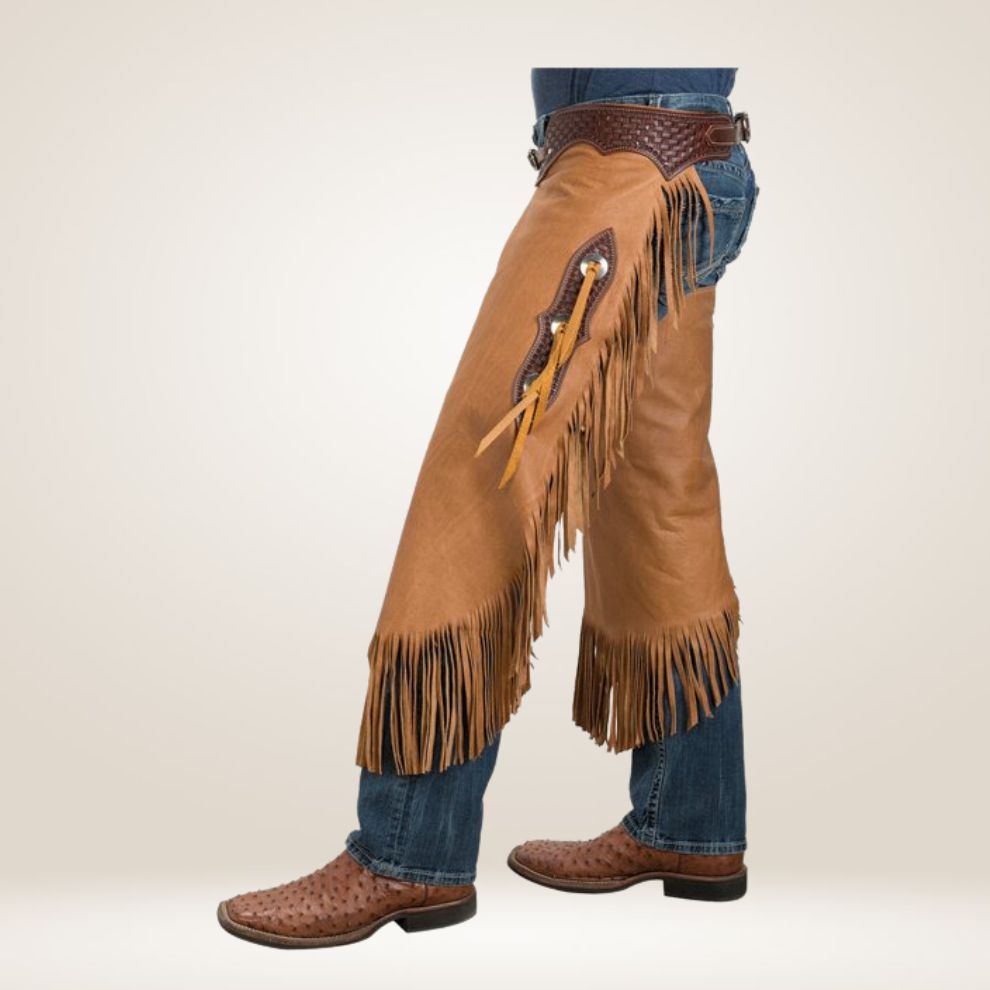 Brown leather chaps with fringes worn over blue jeans on a white background