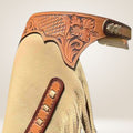 Beige leather glove with brown decorative elements on a light beige background