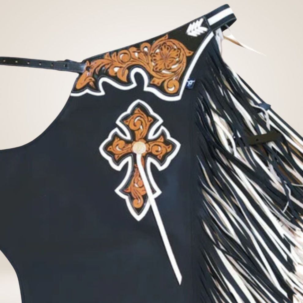 Black fringe chaps with decorative cross and patterns on a white background
