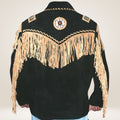 Black leather jacket with beige fringe and intricate designs on a plain background