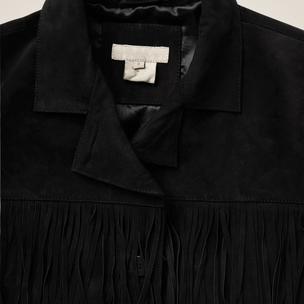 Black jacket with a brand label on a beige background