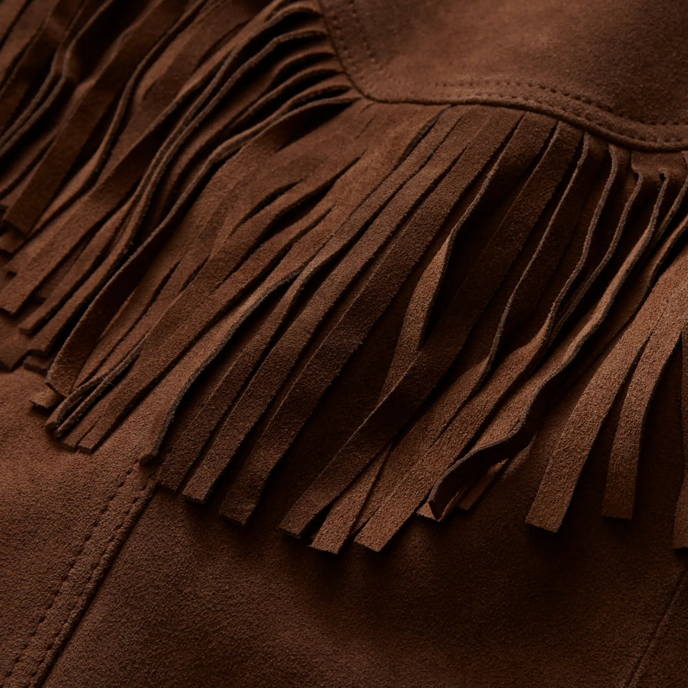Close-up of a brown suede bag with fringes