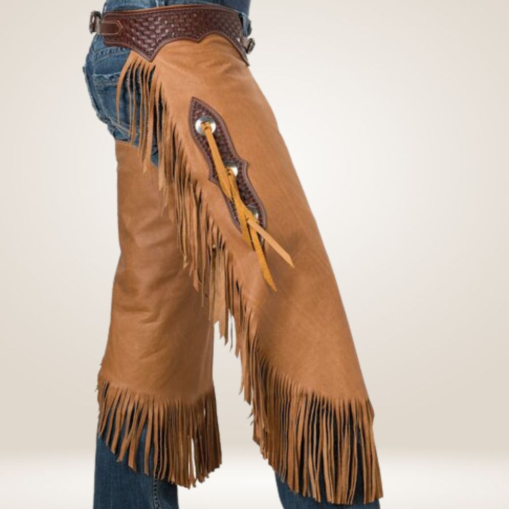 Brown leather chaps with fringes and a belt on a plain background