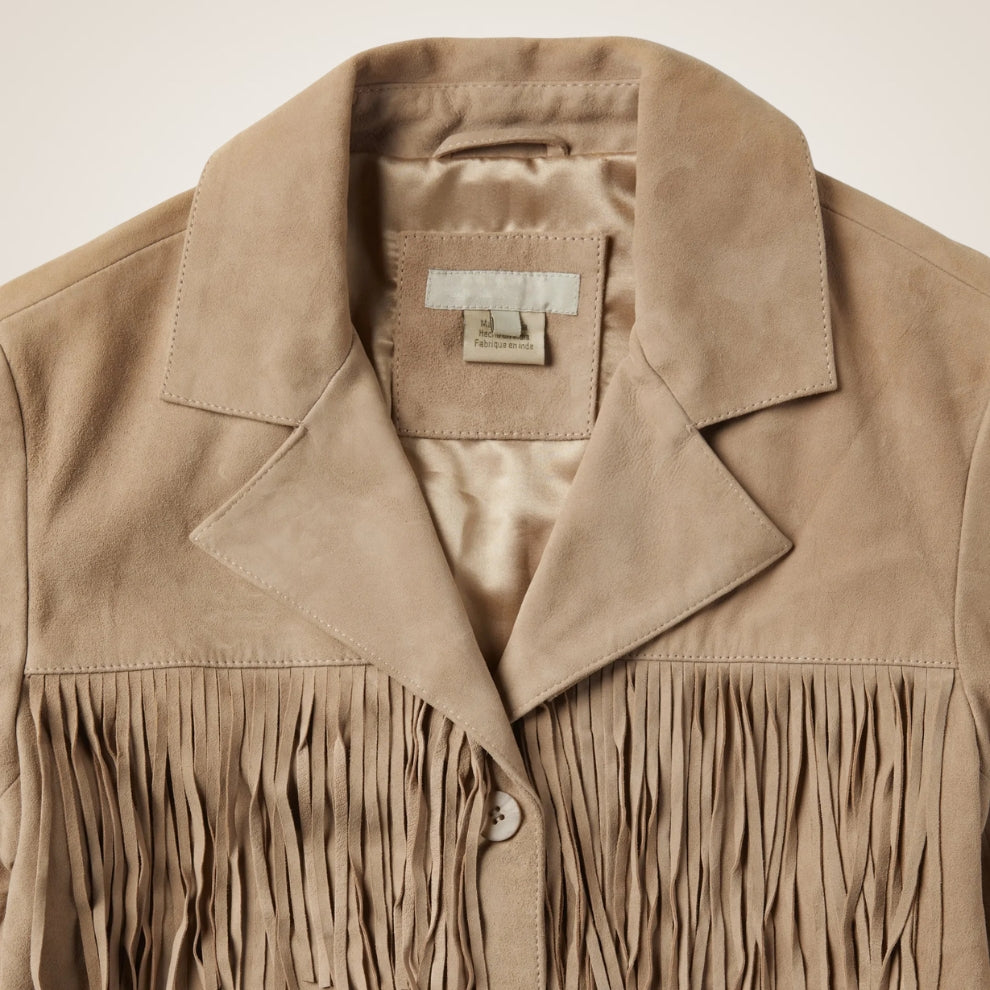 Beige suede jacket with fringes on a beige background