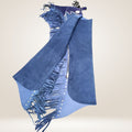Blue suede jacket with fringe details on a beige background