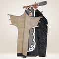 Decorative gun with black fringes and intricate design on a beige background