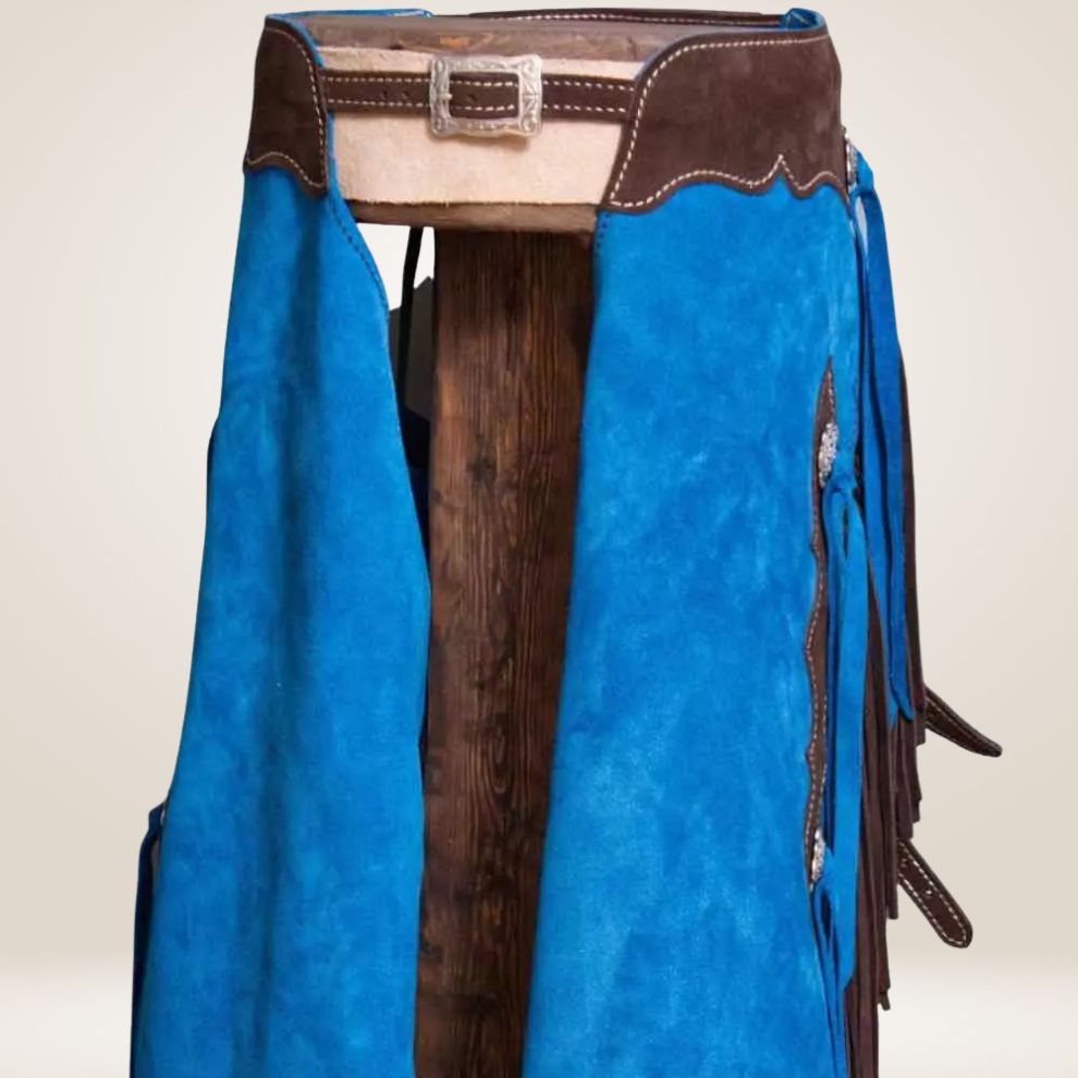 Blue leather bag with brown accents and fringes on a beige background