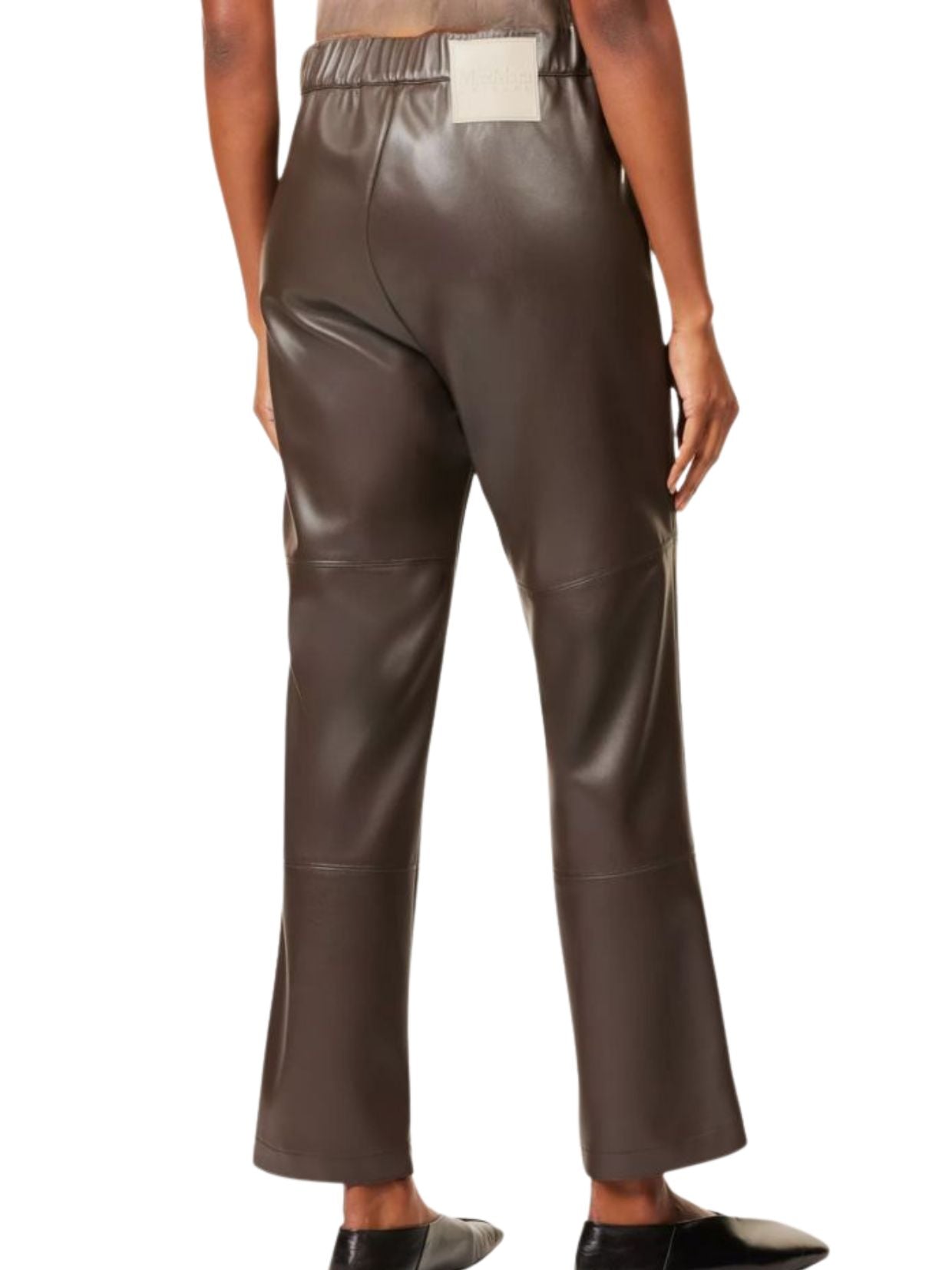 Brown leather pants worn by a person on a white background