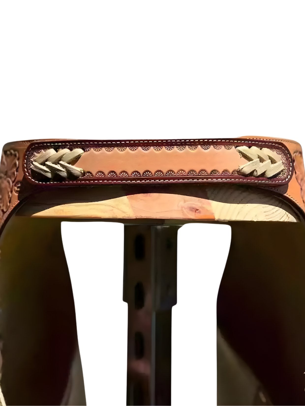 Close-up of a brown leather saddle with intricate stitching on a white background