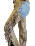 Brown leather pants with fringes and a blue denim patch on a white background