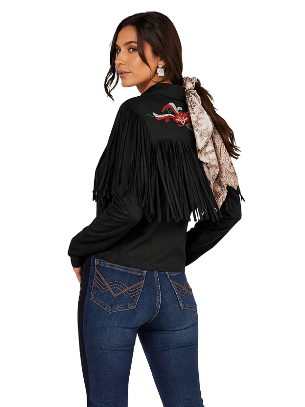 Woman wearing a black fringe jacket with a red and white design on the back, standing against a white background.