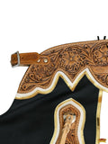 Close-up of a intricately designed leather saddle with floral patterns on a white background