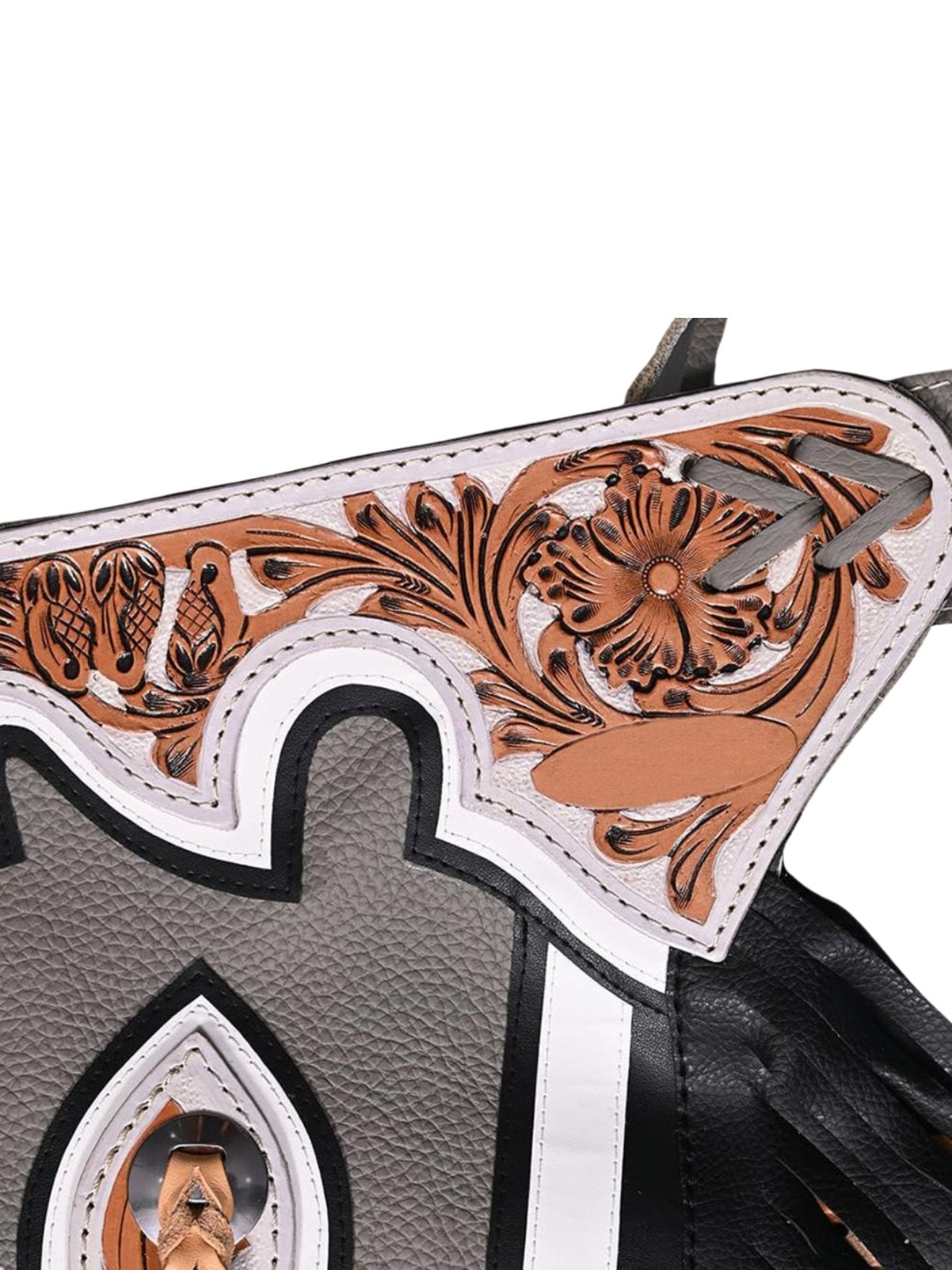 Close-up of a leather belt of the bull riding chaps intricate brown tooled designs on a white background