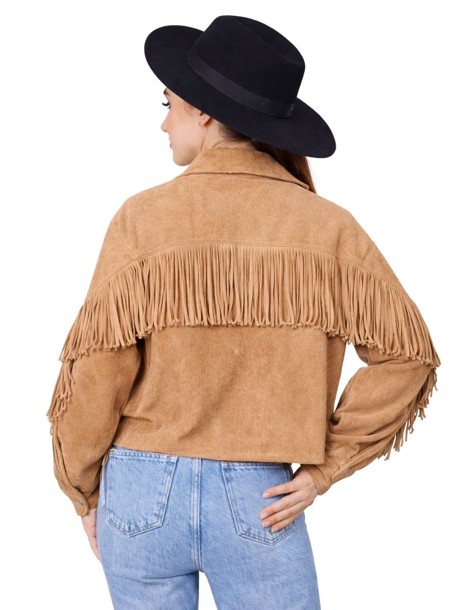 Person wearing a tan fringed jacket and black hat on a white background