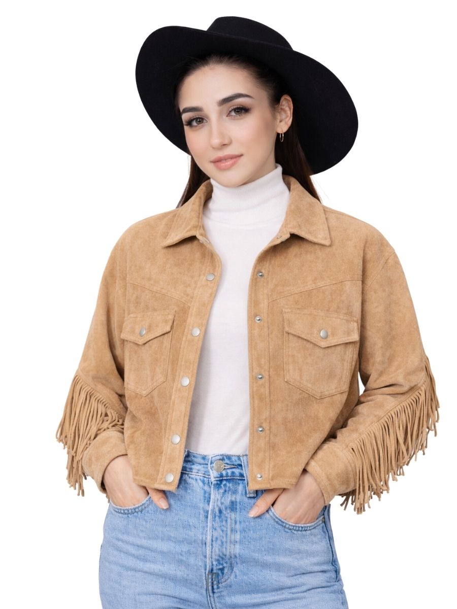 Woman wearing a tan suede jacket with fringe, white turtleneck, and blue jeans on a white background