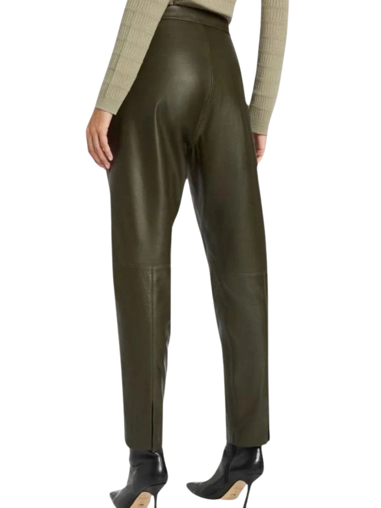 Green leather pants worn by a person on a white background