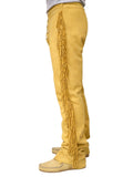 Yellow fringed pants worn by a person on a white background