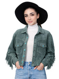 Woman wearing a green suede jacket with fringe, white turtleneck, and blue jeans on a white background