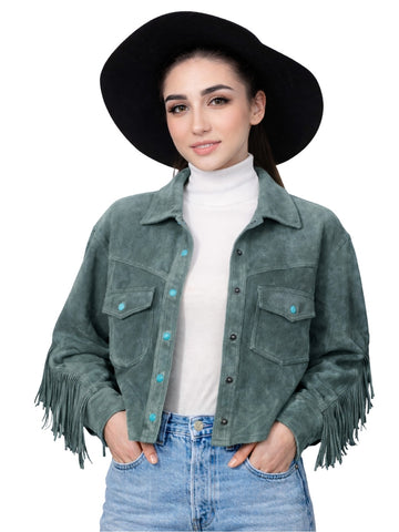 Woman wearing a green suede jacket with fringe, white turtleneck, and blue jeans on a white background